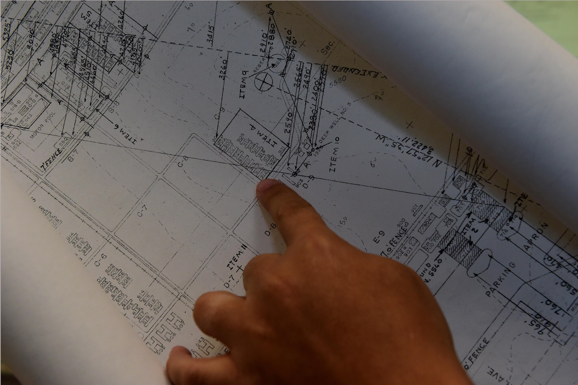 Christopher McCune, 460th Space Wing historian, points at an area on a historical map of Buckley Air Force Base Sept. 26, 2016, at the 460th Space Wing Headquarters building on Buckley AFB, Colo. The map displayed an area that housed African-Americans during a time when our military forces were segregated by race. (U.S. Air Force photo by Airman 1st Class Gabrielle Spradling/Released)