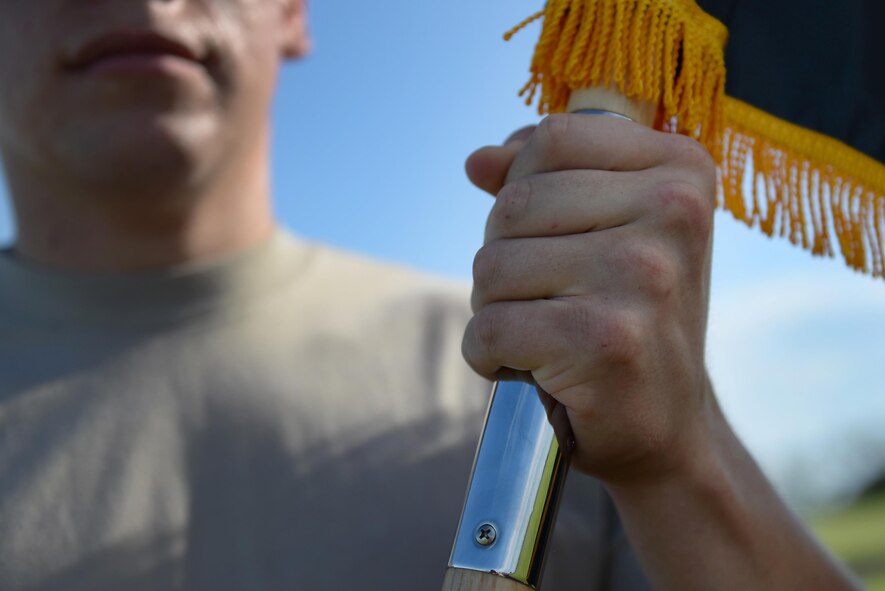 Airman 1st Class Leonardo Meza Camarena, 47th Comptroller Squadron financial services technician, clutches the Prisoners of War/Missing in Action flag during a memorial ruck march on Laughlin Air Force Base, Texas, Sept. 15, 2016. Meza took part in the 24-hour ruck march along with some of his fellow Base Honor Guard members, paying tribute to those missing or captured in battle. (U.S. Air Force photo/ Airman 1st Class Benjamin N. Valmoja)