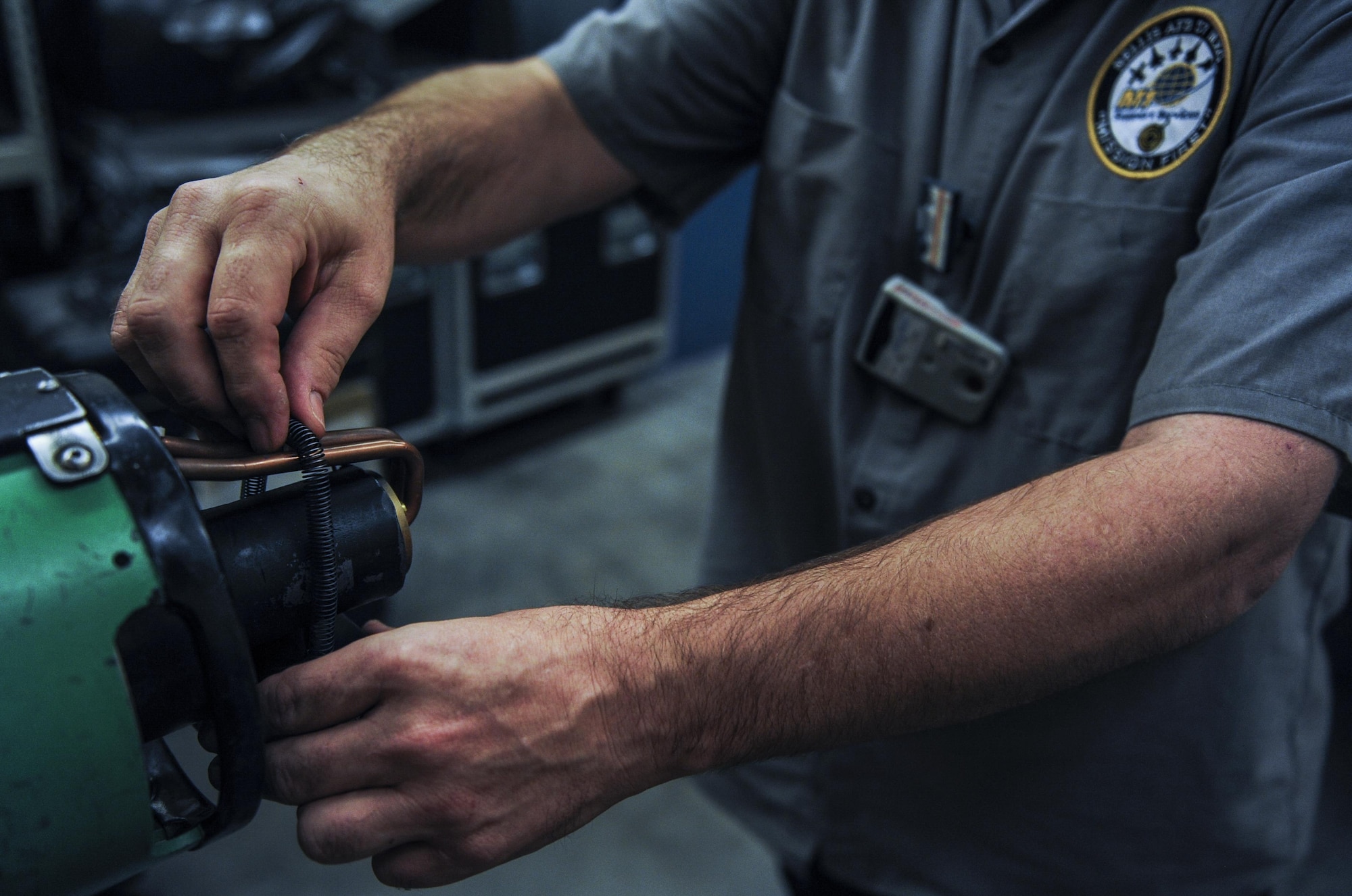 Charles Duke, M1 non-destructive inspection technician, attaches a laser pointer prior to taking an x-ray in the NDI Lab on Nellis Air Force Base, Nev. Sept. 28. The NDI Lab is manned 24 hours a day, seven days a week due to the high number of flights on Nellis AFB. (U.S. Air Force photo by Airman 1st Class Kevin Tanenbaum/Released) 