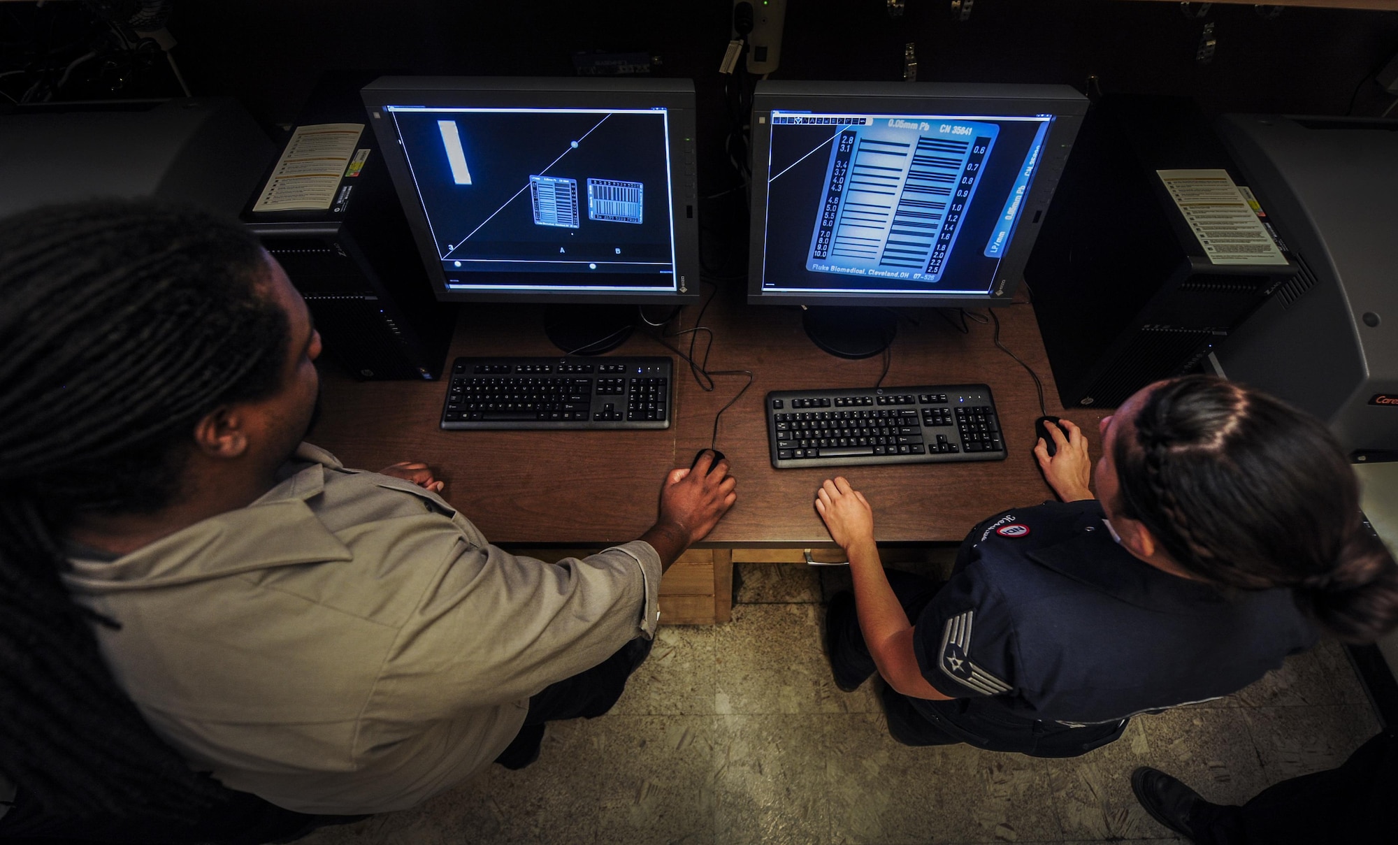 Chas Tedder, M1 non-destructive inspection technician, and Staff Sgt. Samantha Hershberg, United States Air Force Thunderbird  NDI craftsman, train on a new x-ray inspection tool in the NDI lab on Nellis Air Force Base, Nev., Sept. The new x-ray tool can locate even the smallest cracks or inconsistencies in numerous amounts of aircraft parts. (U.S. Air Force photo by Airman 1st Class Kevin Tanenbaum/Released)