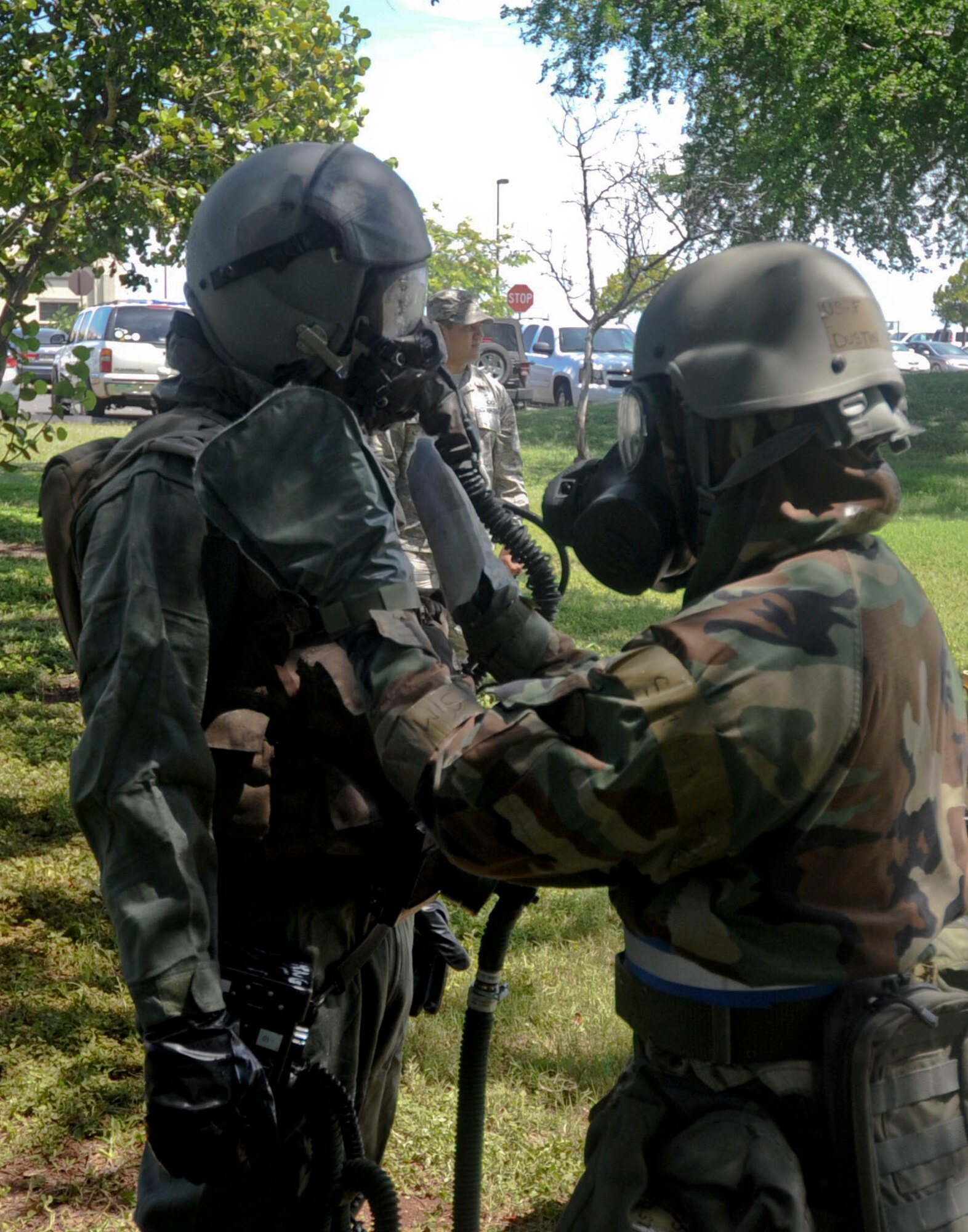 An aircrew flight equipment Airman uses M295 mitts to simulate removing contamination from an aircrew member during the Aircrew Contamination Control Area (ACCA) process as part of Exercise Toxic Pineapple on Joint Base Pearl Harbor-Hickam, Hawaii, Sept. 16, 2016.  The M295 mitts are used to transfer as much charcoal to the aircrew member and equipment as possible. The exercise, which was hosted by the 15th Operations Support Squadron, saw 28 aircrew flight equipment Airmen from Pacific Air Forces, Air Combat Command, and the Air Force Reserve Command learn to set up and run an Aircrew Contamination Control Area in a simulated deployed environment. (U.S. Air Force photo by Tech. Sgt. Terri Paden/Released)