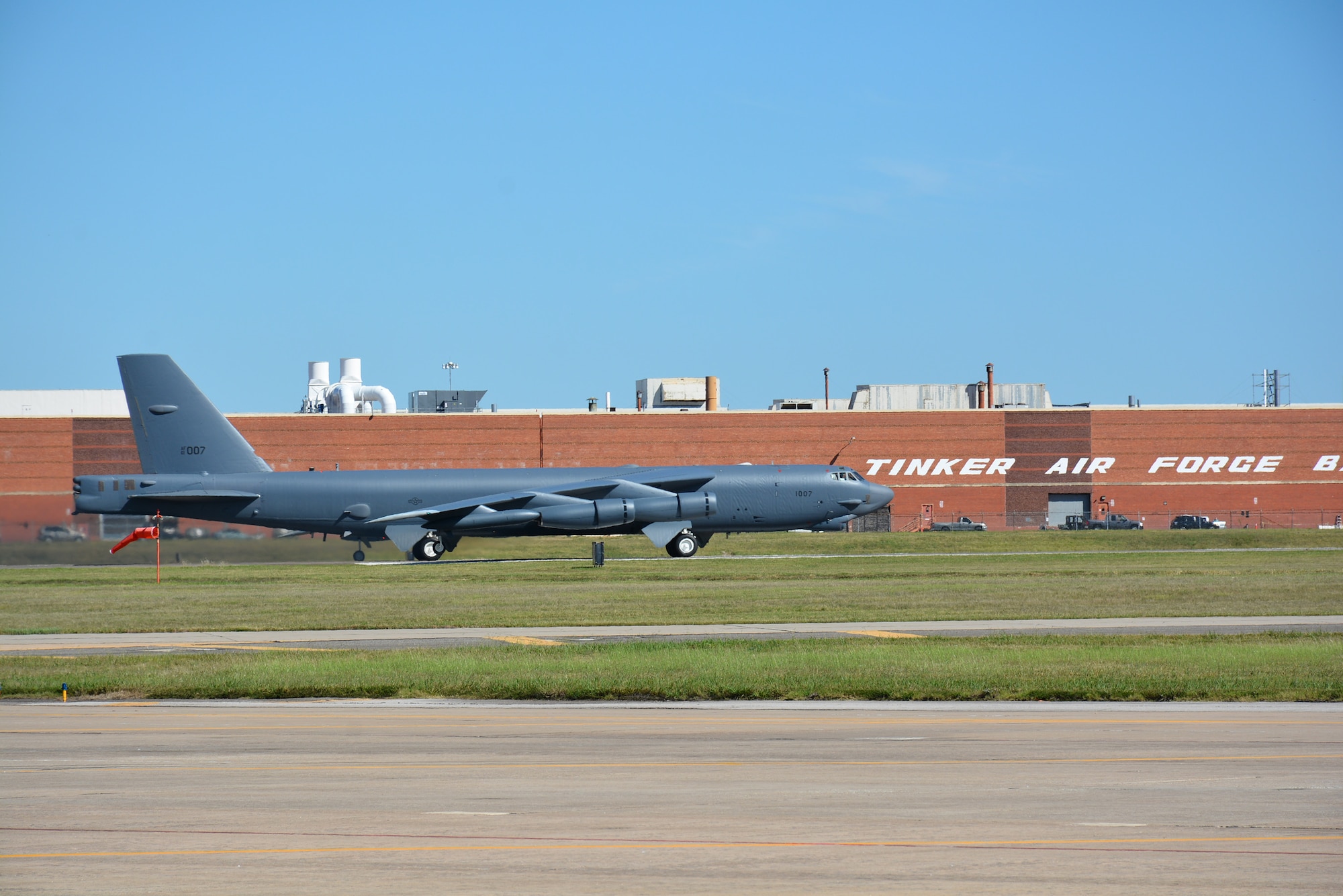 “Ghost Rider,” passes by Bldg. 3001 before taking off for Minot Air Force Base, N.D., where it will rejoin the B-52H fleet. After undergoing a nine-month overhaul and upgrade by the Oklahoma City Air Logistics Complex, 61-007 left Tinker Air Force Base Sept. 27. The historic aircraft is the first B-52H to ever be regenerated from long-term storage with the 309th Aerospace Maintenance and Regeneration Group at Davis-Monthan AFB, Ariz., and returned to full operational flying status. (Air Force photo by Darren D. Heusel)