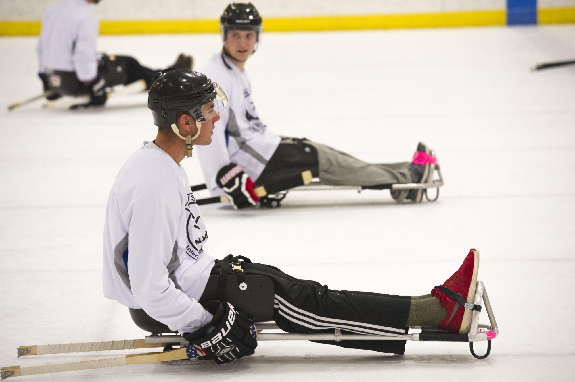 Airman 1st Class Tony Orsini, Fairchild Falcons varsity hockey player, prepares for a faceoff after being scored on in the exhibition sled hockey match at the Frontier Ice Arena here in Coeur d’Alene, Idaho, Sept. 23, 2016. The falcons lost to their opponents who were made up of all-star members of regional hockey teams from Montana, Washington, Texas and Idaho, 14-4. (U.S. Air Force photo/Tech. Sgt. Travis Edwards)
