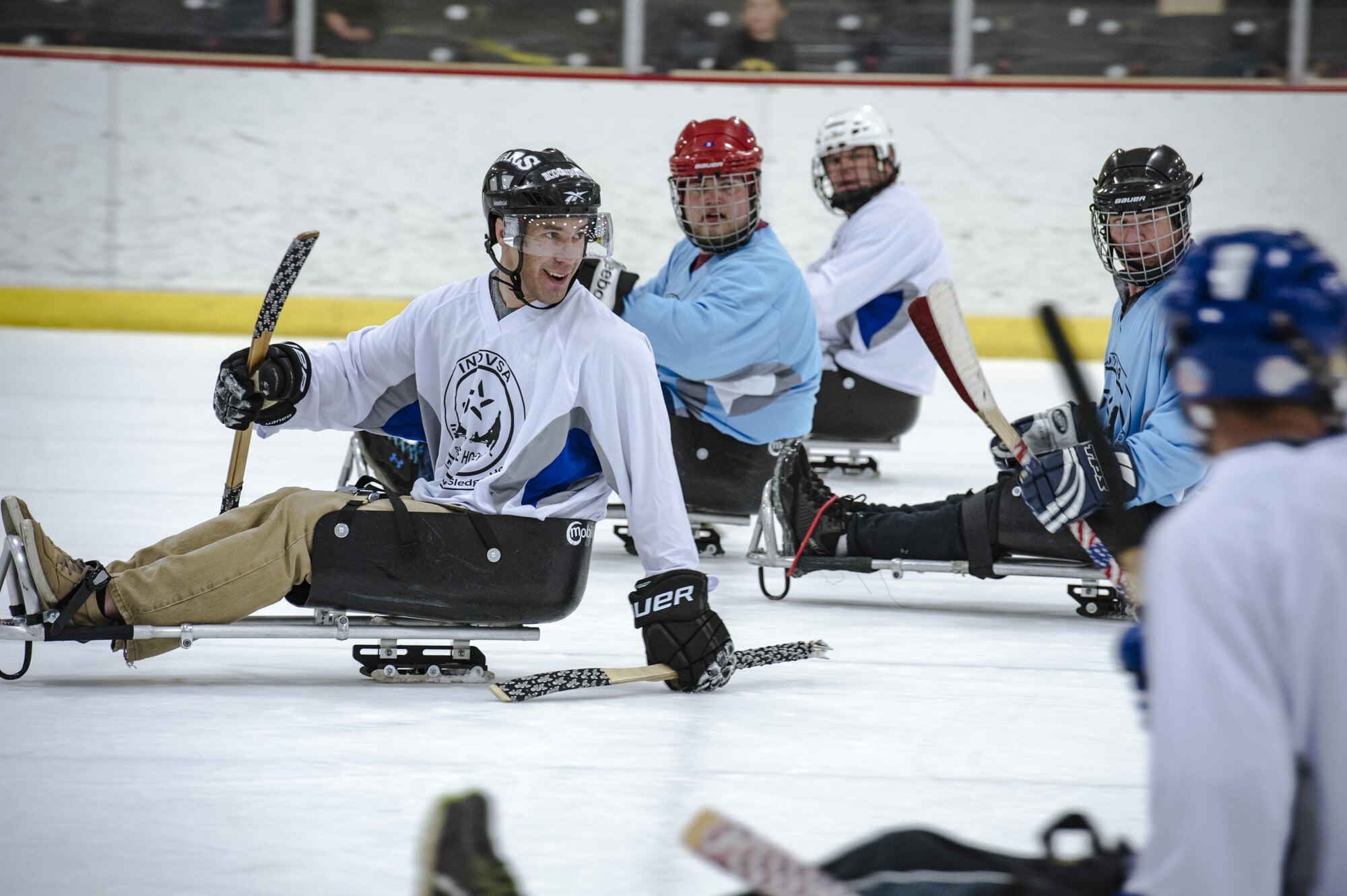 Airman 1st Class Keahi Johnson, Fairchild Falcons varsity hockey player, attempts to slide into a defensive spot as his opponents move into scoring position during exhibition sled hockey match at the Frontier Ice Arena here in Coeur d’Alene, Idaho, Sept. 23, 2016. Sled hockey is a sport designed for athletes with physical disabilities. Specialized gear allows them to play the game of ice hockey with some slight modifications; it is one of the most popular sports in the Winter Paralympic Games. (U.S. Air Force photo/Tech. Sgt. Travis Edwards)
