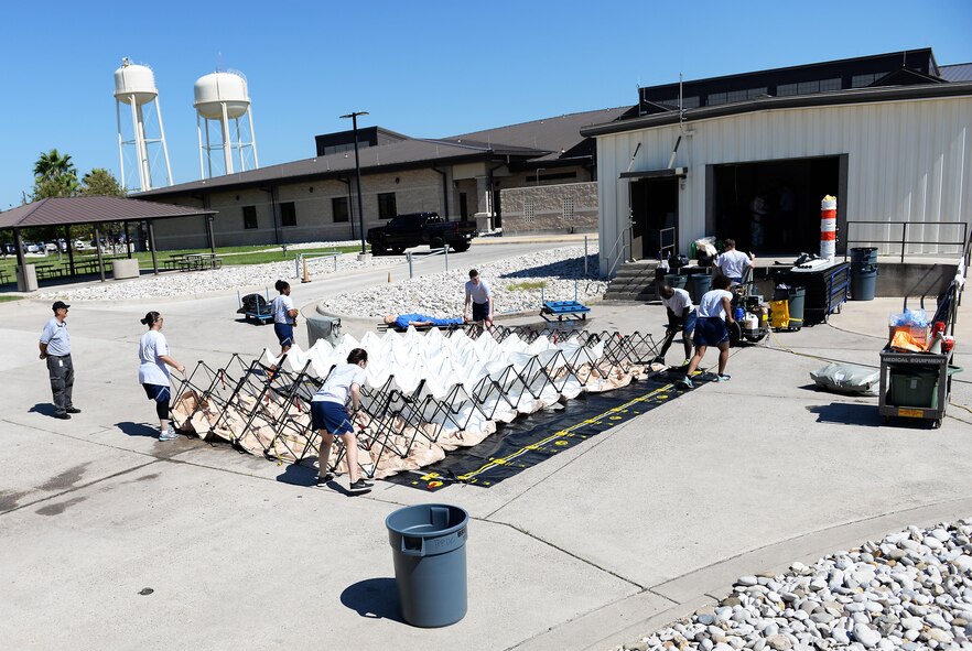 A group of students deploy a tent that will become a medical treatment facility on Laughlin Air Force Base, Texas, Sept. 22, 2016. The team was part of a decontamination training exercise that highlighted combating chemical, biological, radiological and nuclear threats. (U.S. Air Force photo/Airman 1st Class Benjamin N. Valmoja)