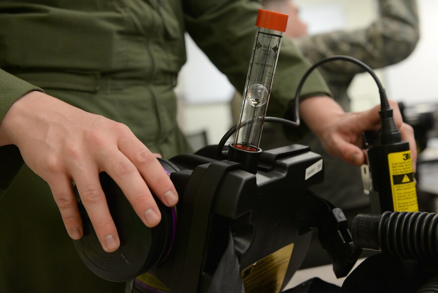 Airman 1st Class Lauri Manuel, 47th Medical Operations Squadron aerospace and operational physiology technician, inspects his ventilation apparatus during a decontamination training course on Laughlin Air Force Base, Texas, Sept. 22, 2016. During the two-day course hosted by the 47th Medical Group, Laughlin Airmen worked closely with Val Verde County medical community members to get hands-on experience with decontamination. (U.S. Air Force photo/Airman 1st Class Benjamin N. Valmoja)