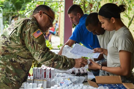 Members of the pharmacy section fill prescriptions during a medical readiness training exercise, or MEDRETE, in the village of Bacadilla, Olancho district, Honduras, Sept. 22, 2016. During this MEDRETE, the pharmacy operated out of a Bacadilla resident’s front porch, which was across the street from the MEDRETE site. (U.S. Air Force photo by Staff Sgt. Siuta B. Ika)