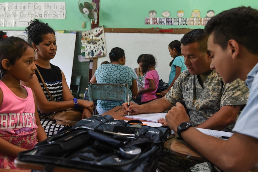 U.S. Army Sgt. Hiram Nieves Jr., Joint Task Force-Bravo Medical Element health care specialist, speaks to patients in the screening section during a medical readiness training exercise, or MEDRETE, in the village of Bacadilla, Olancho district, Honduras, Sept. 23, 2016. After attending the preventive medicine class, patients could receive a consultation from the medical screeners.