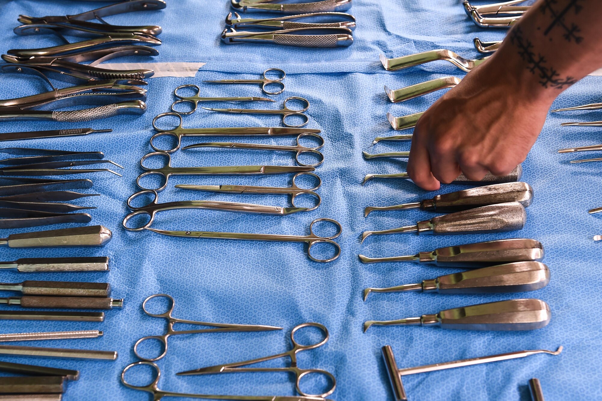 U.S. Army Spc. Tyler Novich, Joint Task Force-Bravo Medical Element dental specialist, reaches for a utensil to aid a dentist in extracting a patient’s tooth during a medical readiness training exercise, or MEDRETE, in the village of Bacadilla, Olancho district, Honduras, Sept. 23, 2016. During the two-day MEDRETE, the dental team treated 119 patients.