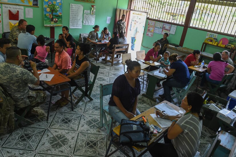 Members of the screening section speak to patients during a medical readiness training exercise, or MEDRETE, in the village of Bacadilla, Olancho district, Honduras, Sept. 23, 2016. During MEDRETEs, personnel from every section of MEDEL come together to help accomplish the mission of delivering medical care in austere conditions, promoting diplomatic relations between the U.S. and host nations in Central America, and providing humanitarian and civic assistance via a long-term proactive program.