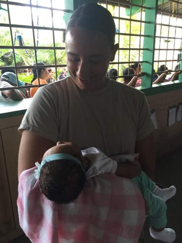 U.S. Army 1st Lt. Jenniffer Rodriguez, Joint Task Force-Bravo Medical Element medical surgical nurse and officer in-charge of the Olancho MEDRETE (medical readiness training exercise) holds and smiles at a baby during a MEDRETE in the village of Bacadilla, Olancho district, Honduras, Sept. 22, 2016. JTF-Bravo has been conducting MEDRETEs throughout Central America since 1993 to provide a variety of medical services to the local populations who otherwise would be unable to receive medical care from licensed providers.