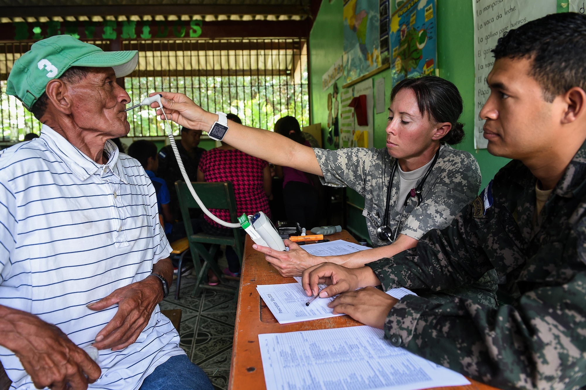 U.S. Army Sgt. Yanna Ramaekers, Joint Task Force-Bravo Medical Element health care specialist, takes a patient’s temperature reading during a medical readiness training exercise, or MEDRETE, in the village of Bacadilla, Olancho district, Honduras, Sept. 22, 2016. Members of the Honduran military and local civilians volunteered their time to translate for the JTF-Bravo MEDEL team.