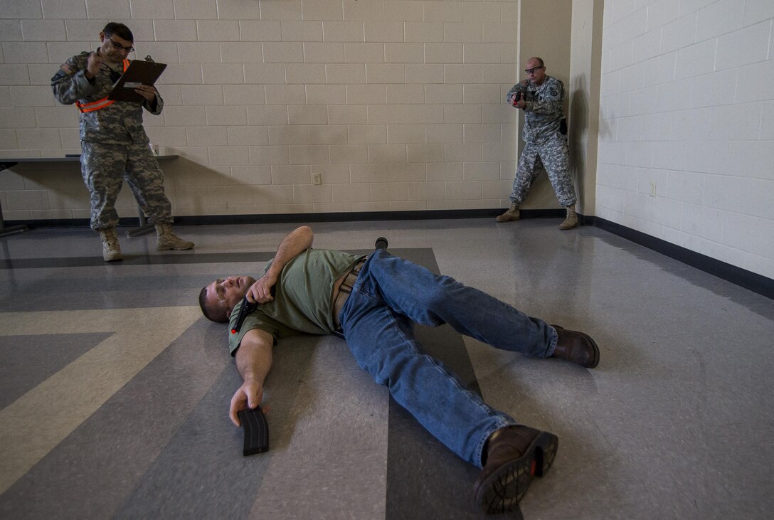 Capt. Andrew Callanan, a U.S. Army Reserve military police officer with the 535th Military Police Battalion, of Cary, North Carolina, pulls security on a suspect during the Active Shooter Threat Response Training taught at an Army Reserve installation in Nashville, Tennessee, on Sept. 27-29. This training is the first program in the Army Reserve to use the latest tactics taught by federal agents to defend against active shooter incidents, which will eventually train all military police armed guards across the 200th Military Police Command. (U.S. Army Reserve photo by Master Sgt. Michel Sauret)