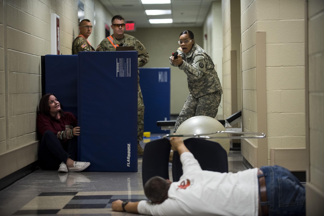 Spc. Megan Barrett, a U.S. Army Reserve military police Soldier with the 724th Military Police Battalion, of Fort Lauderdale, Florida, prepares to engage a suspect during the Active Shooter Threat Response Training taught at an Army Reserve installation in Nashville, Tennessee, on Sept. 29. This training is the first program in the Army Reserve to use the latest tactics taught by federal agents to defend against active shooter incidents, which will eventually train all military police armed guards across the 200th Military Police Command. (U.S. Army Reserve photo by Master Sgt. Michel Sauret)