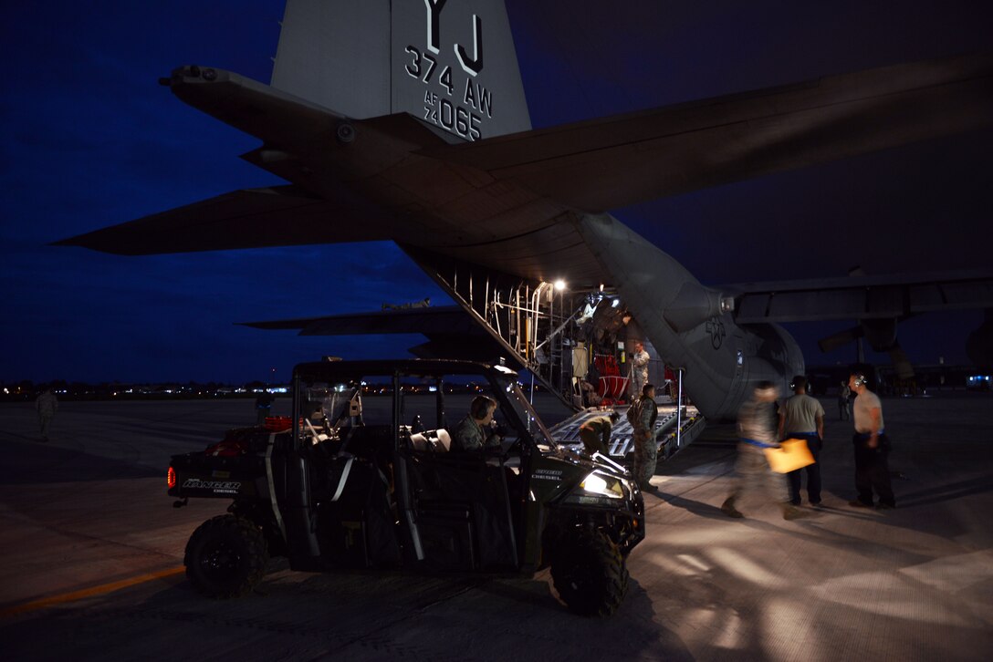 Brigadier General Benito N Ebuen Air Base, Lapu-Lapu City, Philippines—Air Base, Lapu-Lapu City, Philippines—A marshal from the Philippine Air Force directs a Philippine Air Force C-130 to its ramp position following the first bilateral mission of the current iteration of a rotational Air Contingent in the Philippines Sept 26. Two C-130 Hercules aircraft and crews from 374th Airlift Wing, Yokota Air Base, Japan, the 36th Contingency Response Group from Andersen Air Force Base, Guam, and other units from across U.S. Pacific Command will conduct bilateral training missions and subject matter expert exchanges alongside their Philippine Air Force counterparts. The Air Contingent is helping build the capacity of the Philippine Air Force and increases joint training, promotes interoperability and provides greater and more transparent air and maritime situational awareness to ensure safety for military and civilian activities in international waters and airspace. Its missions include air and maritime domain awareness, personnel recovery, combating piracy, and assuring access to the air and maritime domains in accordance with international law. (U.S. Air Force photo by Capt. Mark Lazane)