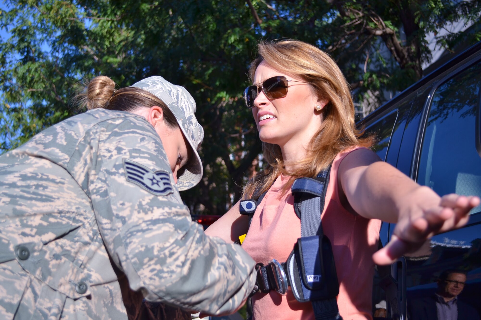 FOX News affiliate's FOX 29 Anchor and Reporter Karen Hepp is secured before being lifted in an Air National Guard bucket truck by Staff Sgt. Michele Hreso, 270th Engineering Installation Squadron member from Horsham Air Guard Station, Pa., during the FOX 29 Salutes the Military event Sept. 23, 2016 in center city Philadelphia. Pa. National Guard members joined members from all other services during the annual event held by the local FOX News affiliate. (U.S. Air National Guard photo by Tech. Sgt. Andria Allmond)