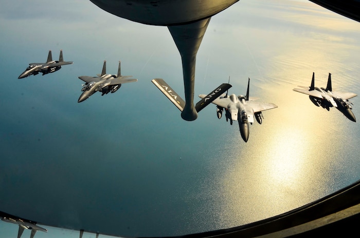 A four-ship of F-15E Strike Eagles, from the 494th Fighter Squadron, RAF Lakenheath, England fly in formation behind a KC-135R Stratotanker from the 117th Air Refueling Wing, Aug. 24, 2016, over the Atlantic Ocean. (U.S. Air National Guard photo by: Senior Airman Wesley Jones)