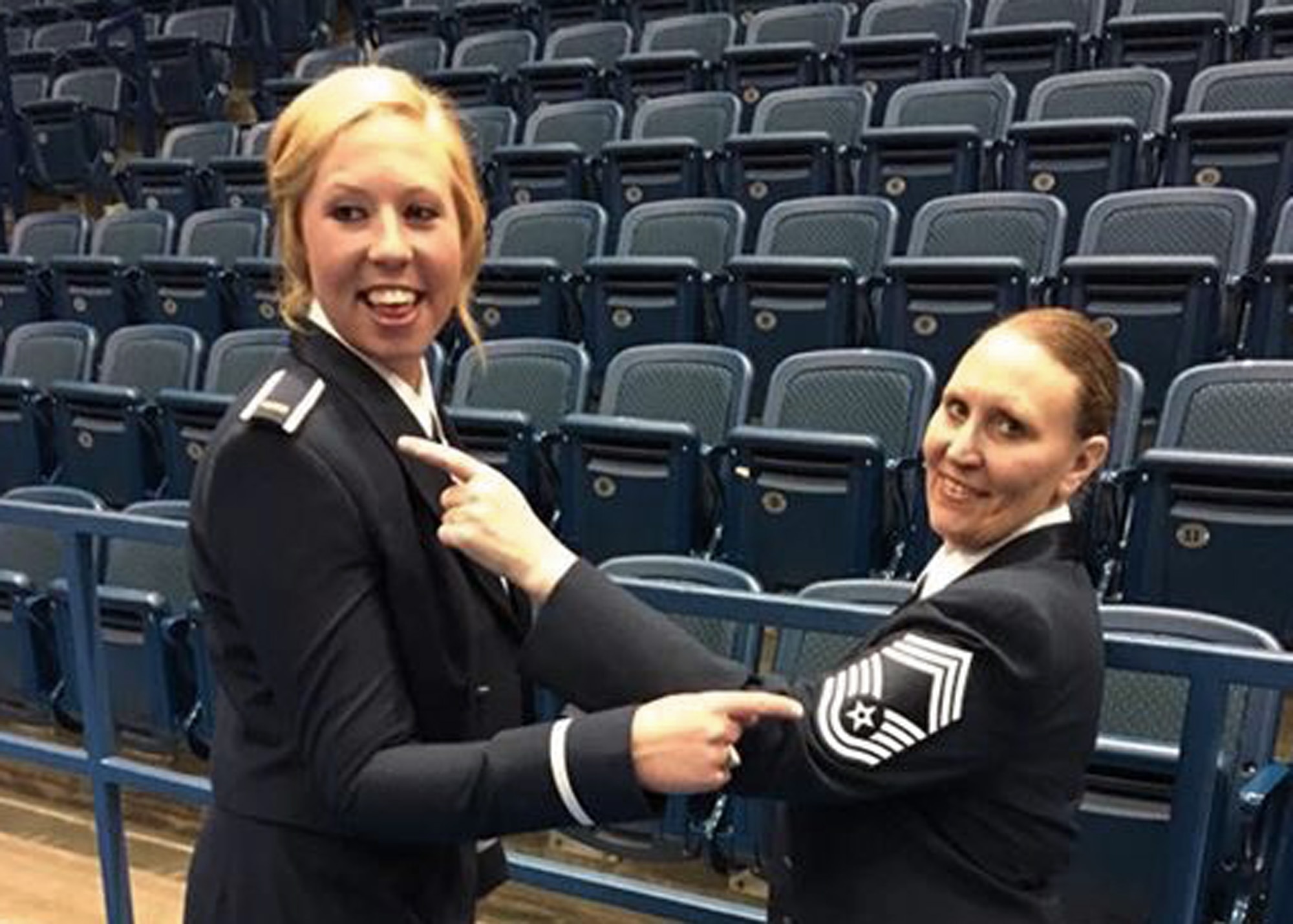 United States Air Force Academy graduate 2nd Lt. Taylor Parker and 120th Airlift Wing Chief Master Sgt. Teresa Parker point to each other’s rank following the USAF Academy commissioning ceremony June 2, 2016. The daughter and mother received their rank on the same day. (Photo courtesy Parker family)