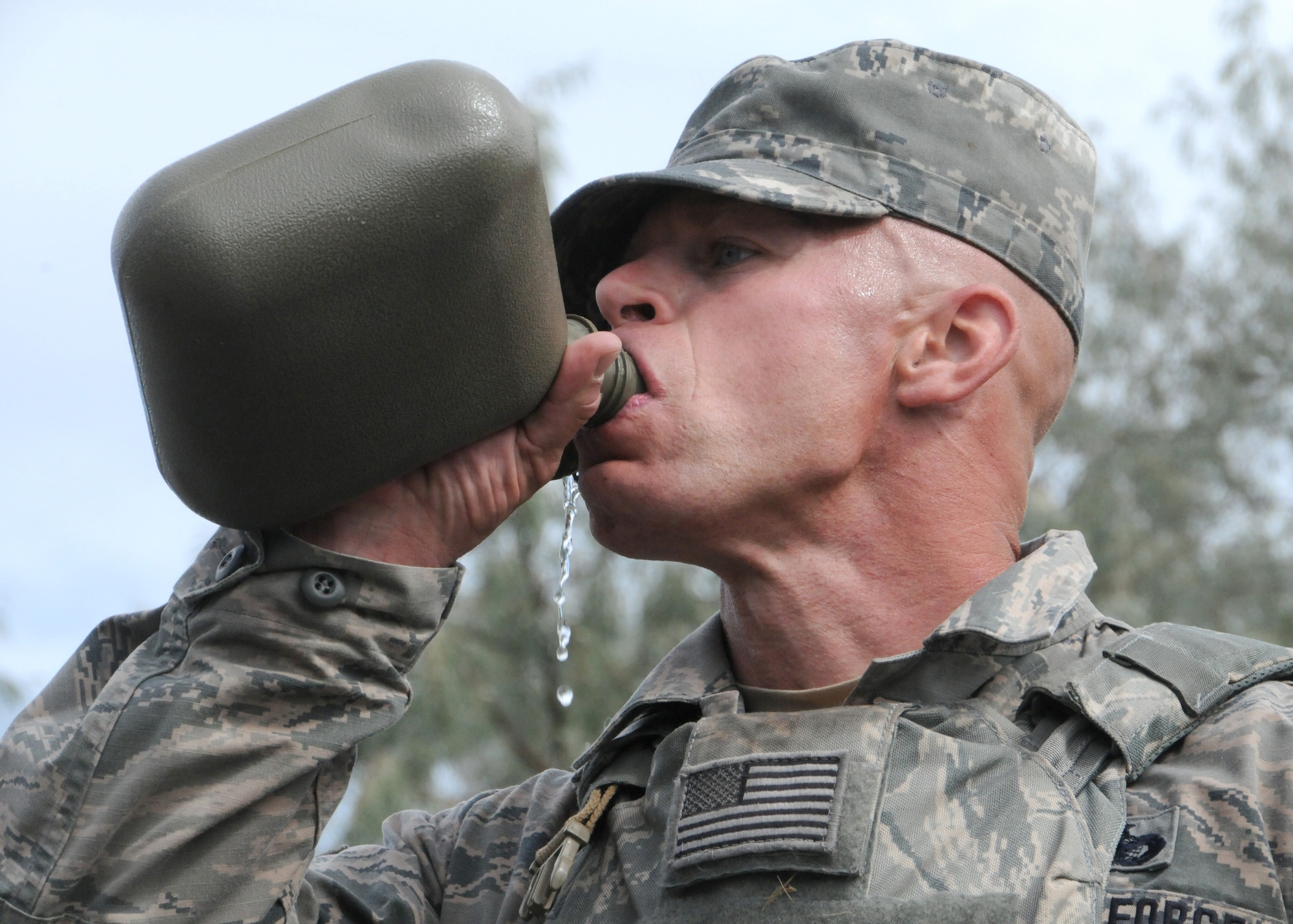 Staff Sgt. Jason Spring, 120th Security Forces, defender takes a drink from his canteen after a 12-mile ruck march after crossing the finish line first at Fort Harrison, Mont., Sept. 10, 2016. Spring, earned third place overall in the Non-commissioned officer category and one of the first two Airmen to compete in the Montana National Guard’s “Best Warrior Competition”. (U.S. Air National Guard photo by Staff Sgt. Lindsey Soulsby/Released)