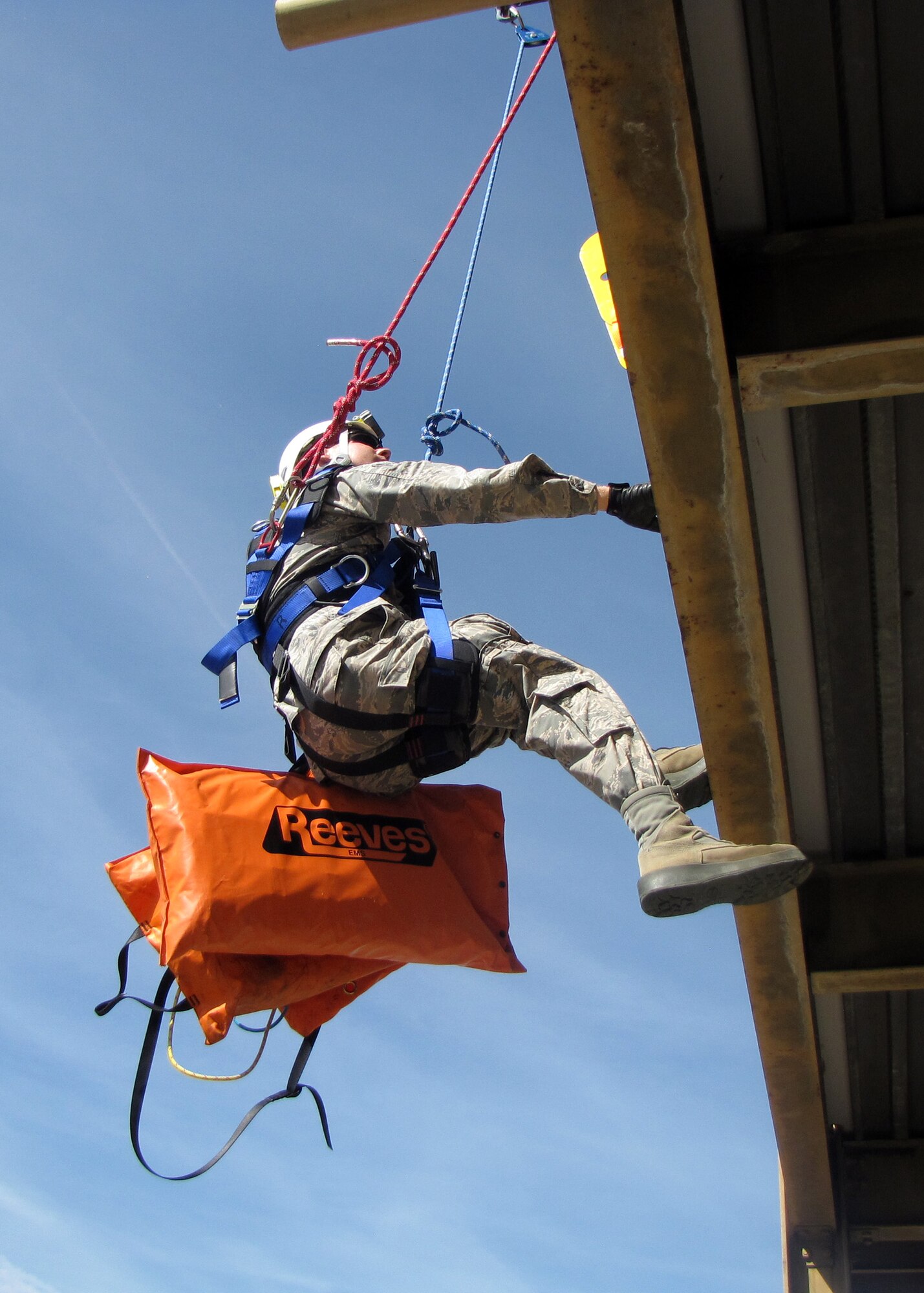 120th Fire and Emergency Services Flight Firefighter Adam Wajer repels down a training tower while transporting patient packaging materials to responders on the ground. Montana Air National Guard firefighters conducted training with the city of Great Falls firefighters at the Charles C. Carrico Regional Training Facility in Great Falls, Mont., Aug. 15-30, 2016. (Photo courtesy 120th Fire and Emergency Services Flight)