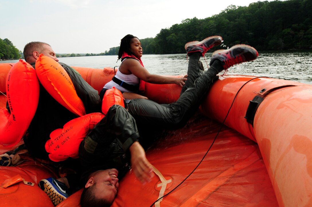 U.S. Air Force Tech. Sgt. Jason Hutton (right), 156th Airlift Squadron, boards a 20-man life raft during a water survival refresher course held at Camp John J. Barnhardt, New London, N.C., Sept. 10, 2016. Hands-on familiarity with all of the emergency equipment kept on the C-130 Hercules aircraft is essential to build muscle memory in times of crisis. Once in the raft, aircrew members practiced survival techniques, water and food procurement, and emergency signaling. (U.S. Air National Guard photo by Staff Sgt. Julianne M. Showalter)