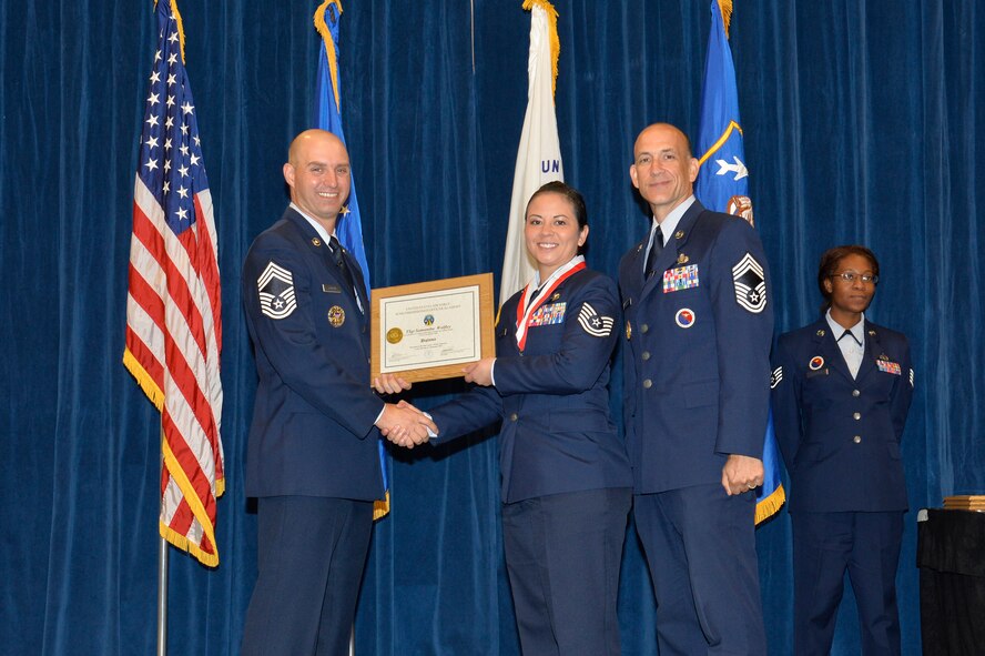 Tech. Sgt. Samantha Wolfley, right, receives the Distinguished Graduate Award for NCO academy class 16-6 from Chief Master Sgt. Paul Rayman, Chief Master Sgt. of Reserve Forces for Headquarters Air Force Space Command, and Chief Master Sgt. Edward Walden, Sr., Commandant of the Paul H. Lankford Enlisted PME Center, here, Sep. 29, 2016, at the I.G. Brown Training and Education Center in Louisville, Tenn. The distinguished graduate award is presented to the top 10 percent of the class.   (U.S. Air National Guard photo by Master Sgt. Jerry D. Harlan/Released)