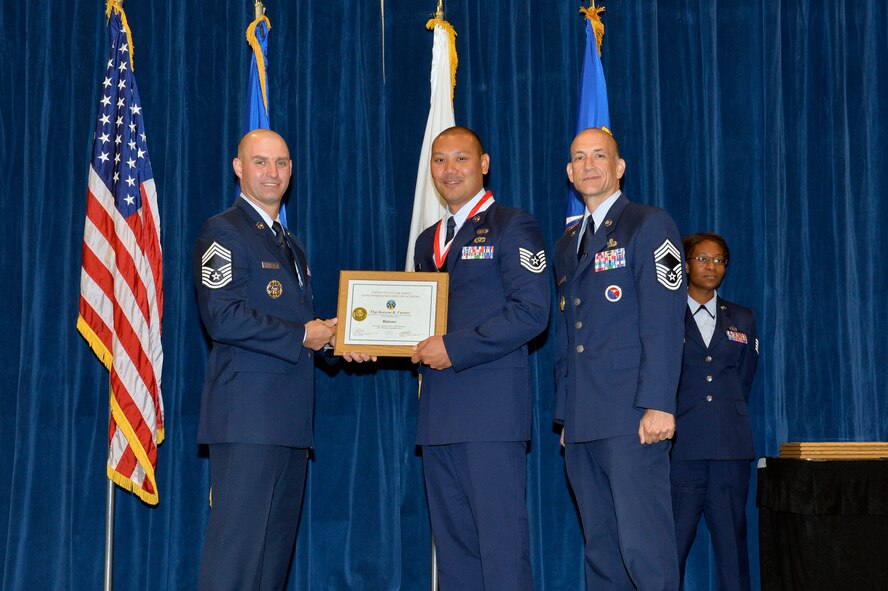 Tech. Sgt. Kareem Fuertes, right, receives the Distinguished Graduate Award for NCO academy class 16-6 from Chief Master Sgt. Paul Rayman, Chief Master Sgt. of Reserve Forces for Headquarters Air Force Space Command, and Chief Master Sgt. Edward Walden, Sr., Commandant of the Paul H. Lankford Enlisted PME Center, here, Sep. 29, 2016, at the I.G. Brown Training and Education Center in Louisville, Tenn. The distinguished graduate award is presented to the top 10 percent of the class.   (U.S. Air National Guard photo by Master Sgt. Jerry D. Harlan/Released)