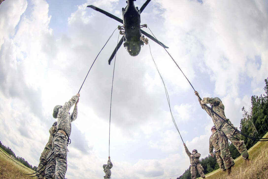 Four soldiers hold ropes attached to a UH-60M Black Hawk as part of training to rappel from a helicopter at Fort Bragg, N.C., Sept. 28, 2016. The helicopter is  assigned to the 82nd Airborne Division's 2nd Assault Helicopter Battalion, 82nd Combat Aviation Brigade. Army photo by Capt. Adan Cazarez
