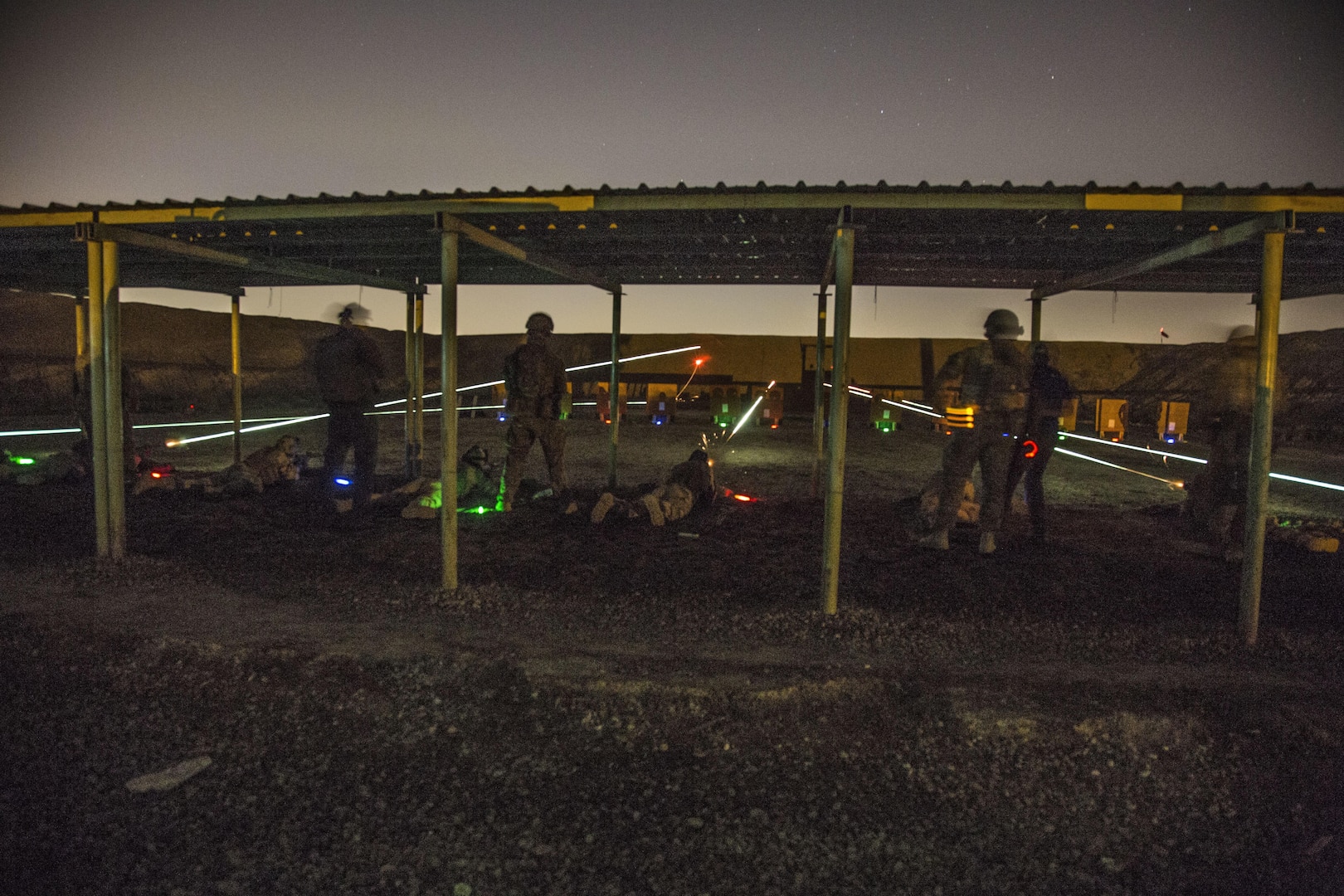 Australian soldiers, assigned to Task Group Taji, observe Iraqi soldiers with the Security Battalion, Nineveh Operations Command, firing their AK-47 rifles during night range training at Camp Taji, Iraq, April 3, 2016. Task Group Taji conducted night range training to gauge the Iraqi soldiers night firing capabilities. Training at the building partner capacity sites is an integral part of Combined Joint Task Force – Operation Inherent Resolve’s multinational effort to train Iraqi security force personnel to defeat the Islamic State of Iraq and the Levant. (U.S. Army Photo by Spc. William Lockwood)