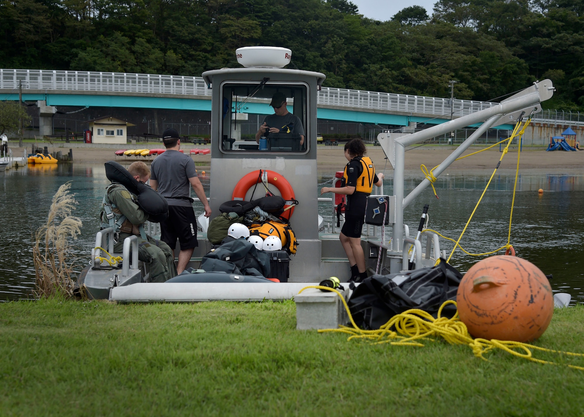 Survival, Evasion, Resistance, and Escape specialists and cadre members prepare the USS Magnum, a training boat, on Lake Ogawara before beginning the practical part of the water survival refresher course, at Misawa Air Base, Japan, Sept. 20, 2016. During the course, 35th Fighter Wing pilots undergo an hour of academic learning to discuss their kits in an open water environment, then demonstrate practical lessons in the water. (U.S. Air Force photo by Senior Airman Deana Heitzman)