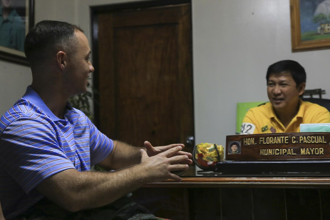 U.S. Marine Capt. Justin Kabilian, a native of Marshfield, Mass., and the civil affairs team leader with III Marine Expeditionary Force, speaks with Florante C. Pascual, municipal mayor of Lal-lo, Philippines, about future humanitarian civic assistance projects for Philippine Amphibious Landing Exercise 33 (PHIBLEX) here, Sept 26, 2016. PHIBLEX 33 is an annual U.S.-Philippine military bilateral exercise that combines amphibious landing and live-fire training with humanitarian civic assistance efforts to strengthen interoperability and working relationships. (U.S. Marine Corps photo by MCIPAC Combat Camera Cpl. Allison Lotz/Released)