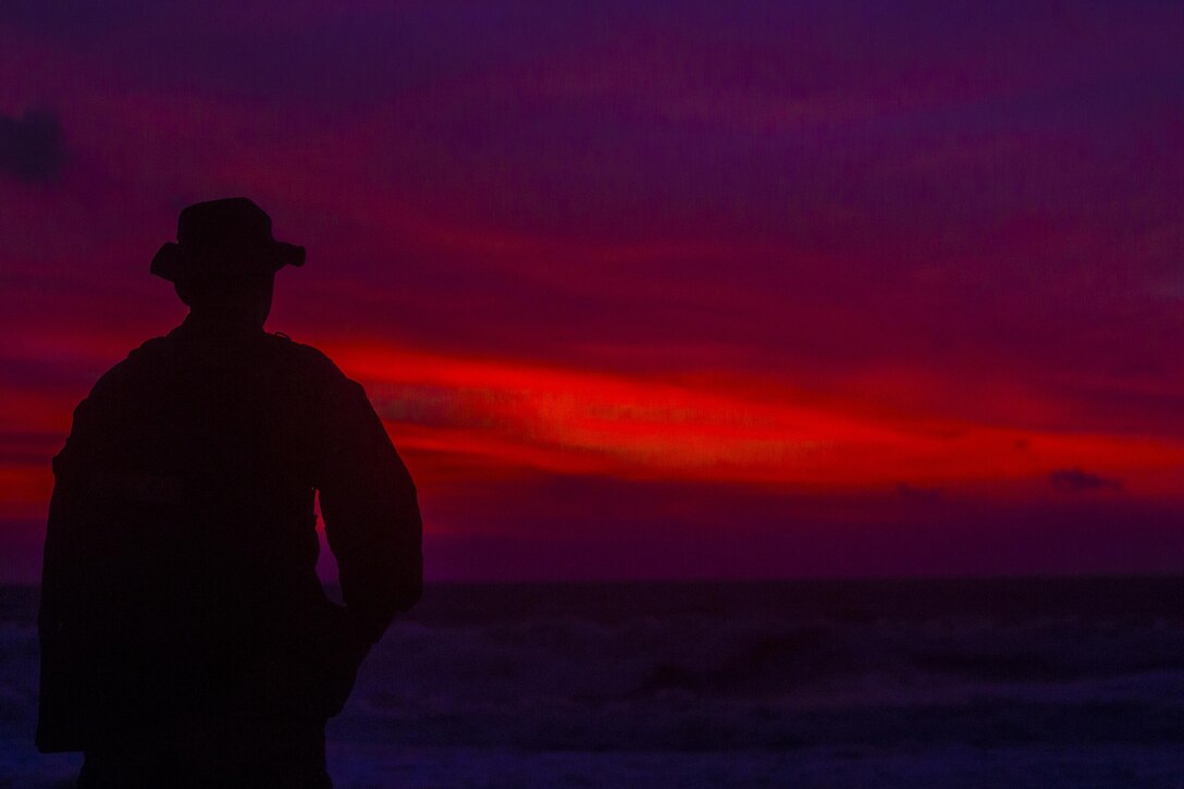 U.S. Marine Sgt. Scotty Gustafson, an engineer with Bravo Company, 9th Engineer Support Battalion, 3d Marine Logistics Group, watches the sunset after working at a humanitarian civic assistance project during Philippine Amphibious Landing Exercise 33 (PHIBLEX) here, Sept 26, 2016. PHIBLEX 33 is an annual U.S.-Philippine military bilateral exercise that combines amphibious landing and live-fire training with humanitarian civic assistance efforts to strengthen interoperability and working relationships. (U.S. Marine Corps photo by MCIPAC Combat Camera Cpl. Allison Lotz/Released)
