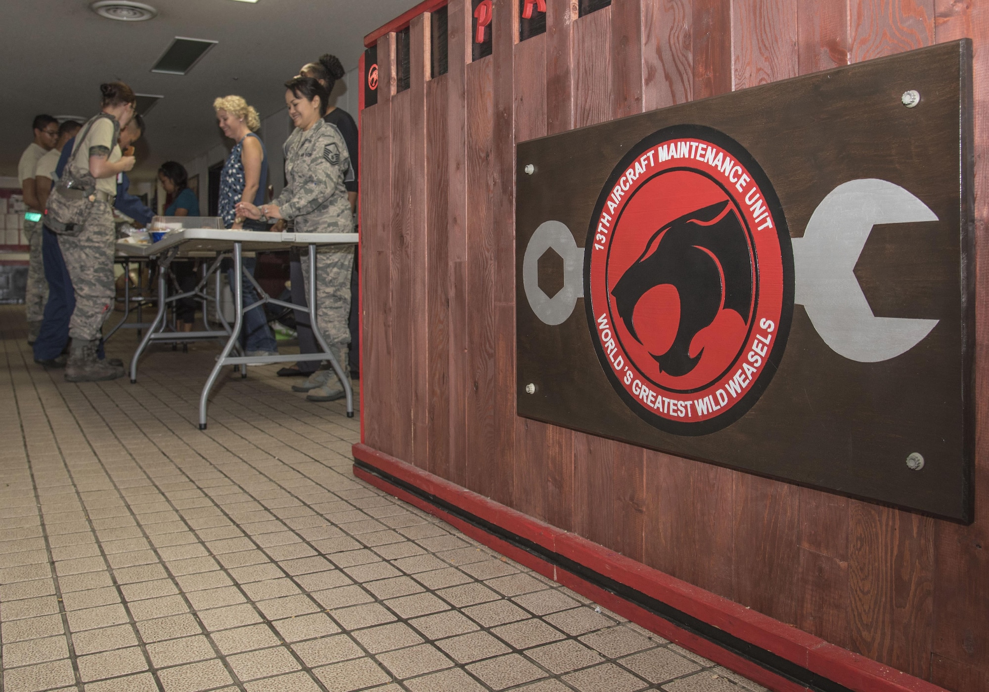 Airmen with the 13th Aircraft Maintenance Unit line up to receive food during a "Hearts on the Flight Line" event at Misawa Air Base, Japan, Sept. 28, 2016. Food was distributed to Airmen at the 13th and 14th AMUs, as well as the ammunitions and propulsion shops. Hearts on the Flight Line, coordinated by the Chaplain Corps and squadron leaders, reaches out to lift the spiritual, social, psychological and emotional well-being of Airmen. (U.S. Air Force photo by Airman 1st Class Sadie Colbert)