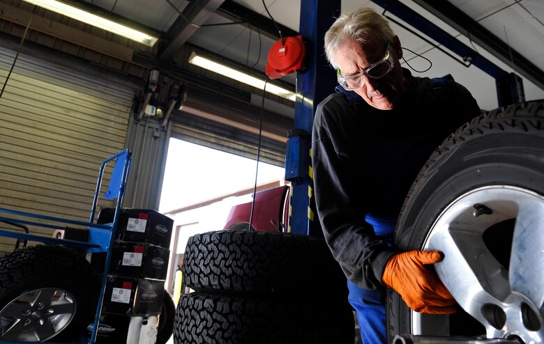Greg Hermann, 86th Force Support Squadron tire technician, measures a winter tire for its weight balance Sept. 28, 2016, at Ramstein Air Base, Germany. German law states that every motor vehicle is required to have all-season or winter tires during winter conditions including ice, black ice, frost, snow and slush. (U.S. Air force photo/Airman 1st Class Lane T. Plummer)