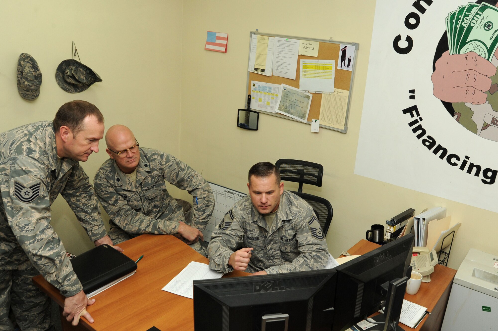 Members of the 386th Air Expeditionary Wing finance office work together on a project to close out the fiscal year Sep. 29, 2016 at an undisclosed location in Southwest Asia. During the end of year close out, finance obligated more than $9 million and made vendor payments totaling more than $300,000. (U.S. Air Force photo/Senior Airman Zachary Kee)