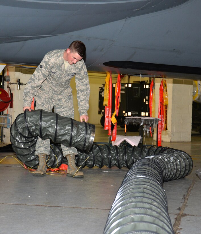 U.S. Air Force Senior Airman Tyler Harvey, 100th Maintenance Squadron shift leader of consolidated tool kits, moves a purging duct to verify it’s bonded to the aircraft properly Sept. 13, 2016, on RAF Mildenhall, England. Anything that touches the aircraft has to be grounded and bonded because of static electricity that could build up and create a spark. (U.S. Air Force photo by Gina Randall)