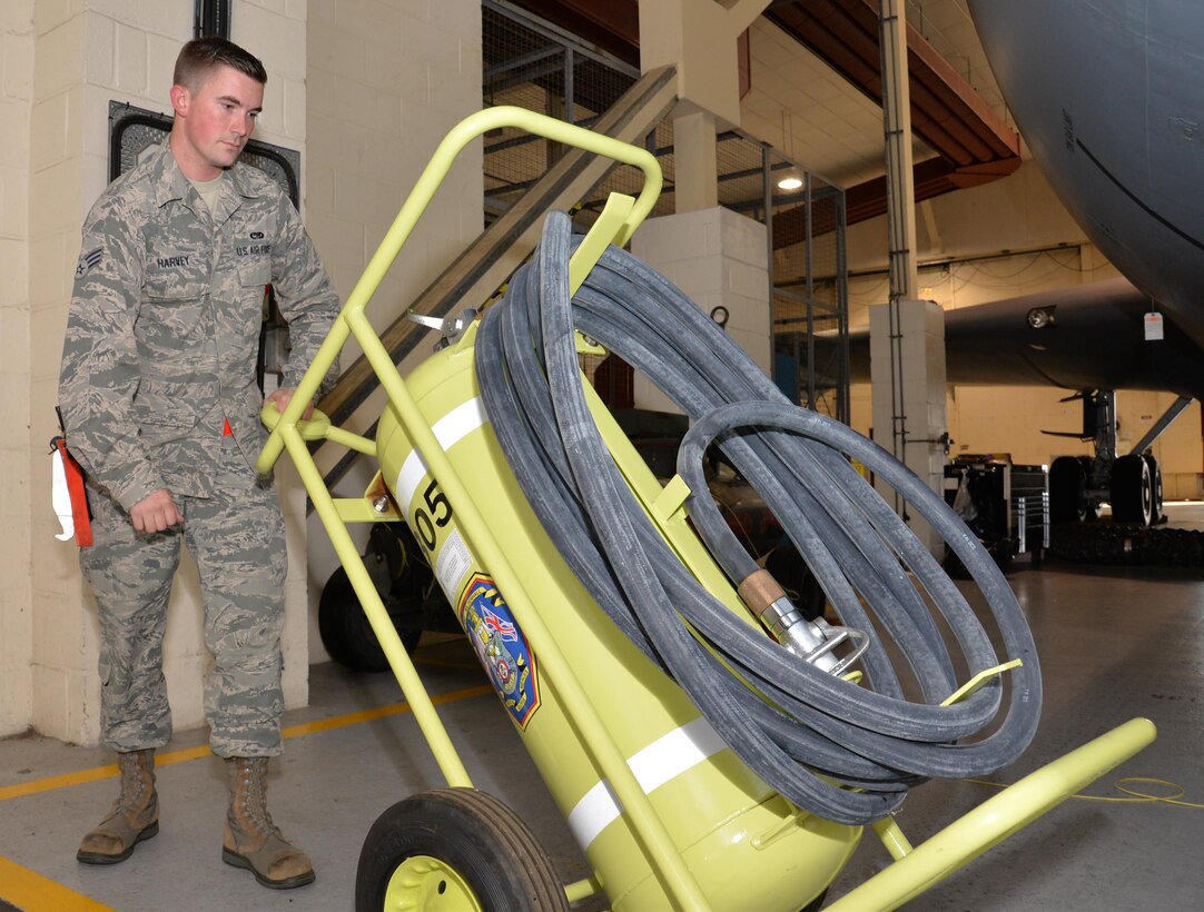 U.S. Air Force Senior Airman Tyler Harvey, 100th Maintenance Squadron shift leader of consolidated tool kits, moves a Halon fire bottle Sept. 13, 2016, on RAF Mildenhall, England. Harvey checks them for their inspection period and for serviceability. The fire bottles must be inspected prior to maintenance, monthly, and annually, for serviceability. (U.S. Air Force photo by Gina Randall)