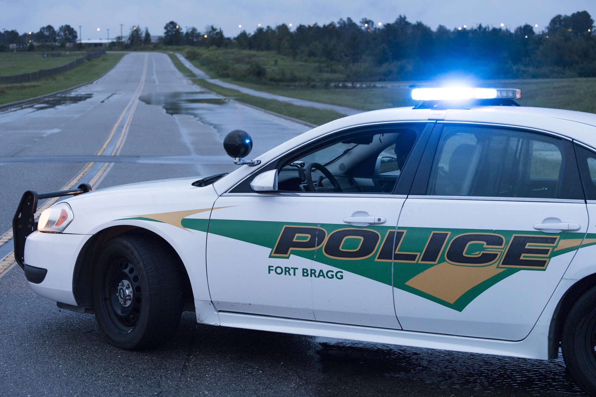 POPE FIELD, N.C. -- A Fort Bragg military policeman blocks traffic on Hurst Road near the flightline here, protecting drivers from deep running water further up the road Sept. 29. A storm in the area dumped more than nine inches of rain on the base in two days, resulting in flooding and washed out roads around the installation. (U.S. Air Force photo/Marc Barnes)  