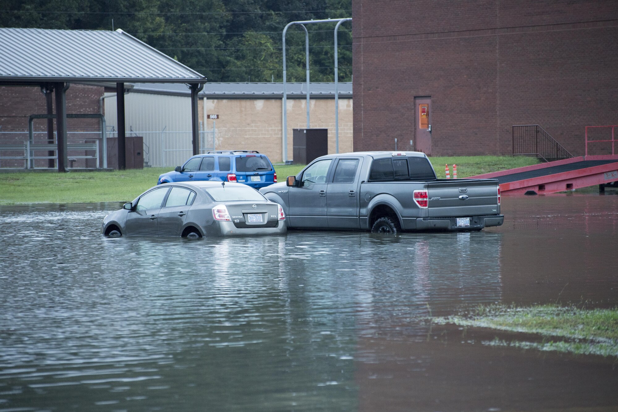 POPE FIELD, N.C. -- Vehicles sit partially submerged in water near the 18th Air Support Operations Group headquarters here Sept. 29 following a storm here which dumped more than nine inches of rain on the base in two days, resulting in flooding and washed out roads around the installation. (U.S. Air Force photo/Marc Barnes)  
