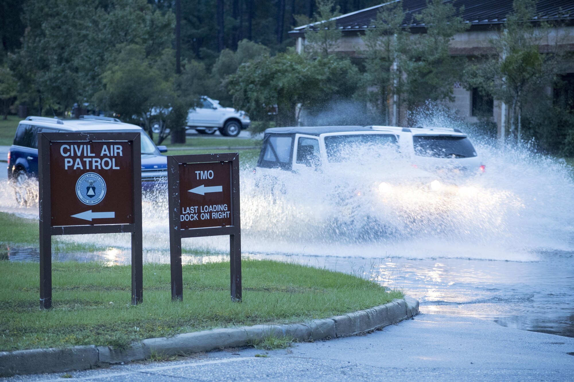 POPE FIELD, N.C. -- Vehicles make a big splash while driving through deep water here Sept. 29, following a storm here which dumped more than nine inches of rain on the base in two days, resulting in flooding and washed out roads around the installation. (U.S. Air Force photo/Marc Barnes)  