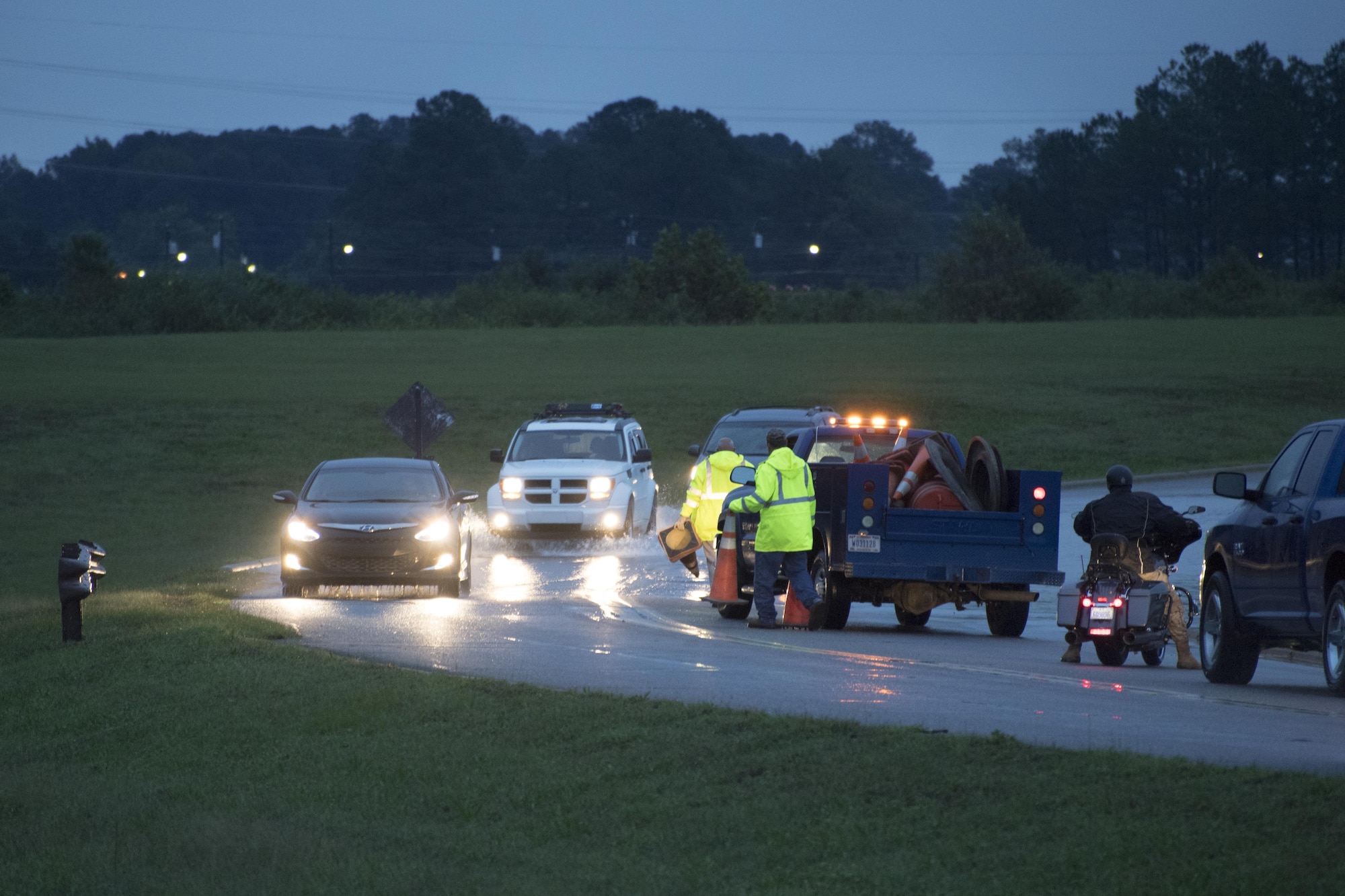 POPE FIELD, N.C. -- Fort Bragg officials prepare to block a lane on Reilly Road near the flightline here Sept. 29, following a storm here which dumped more than nine inches of rain on the base in two days, resulting in flooding and washed out roads around the installation. Water near the road reached more than six feet following the storm, and slowed traffic to a crawl. (U.S. Air Force photo/Marc Barnes)  