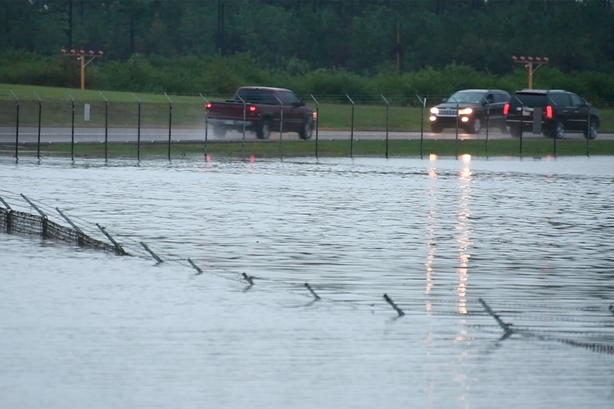 POPE FIELD, N.C. -- A fence surrounding the flightline here is almost entirely submerged in floodwater after a storm in the area dumped more than nine inches of rain on the base in two days, resulting in flooding and washed out roads around the installation. Water crossing nearby Reilly Road slowed traffic to a crawl. (U.S. Air Force photo/Marc Barnes)  