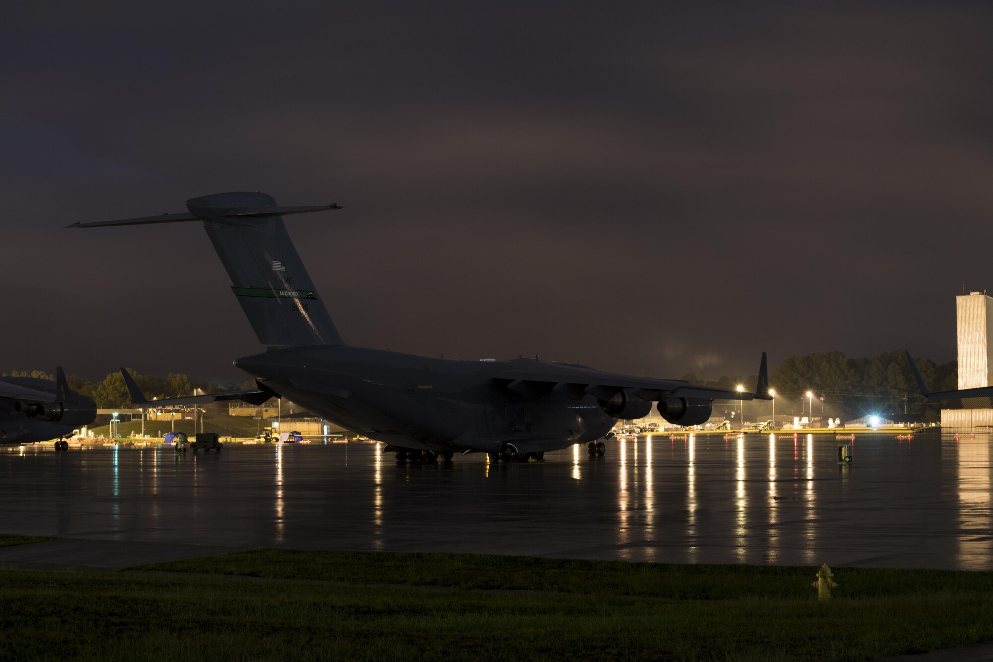 POPE FIELD, N.C. -- A C-17 Globemaster III from Joint Base Lewis-McChord, Washington, sits on Green Ramp here early Sept. 29 during a storm which dumped more than nine inches of rain on the base in two days, resulting in flooding and washed out roads around the installation. Crews from McChord and other Air Mobility Command bases rode out the storm while waiting to resume operations during Large Package Week, a quarterly exercise which provides vital airlift training for Air Force crews from Pope and AMC bases nationwide, and for Fort Bragg Army paratroopers and support units. (U.S. Air Force photo/Marc Barnes)  