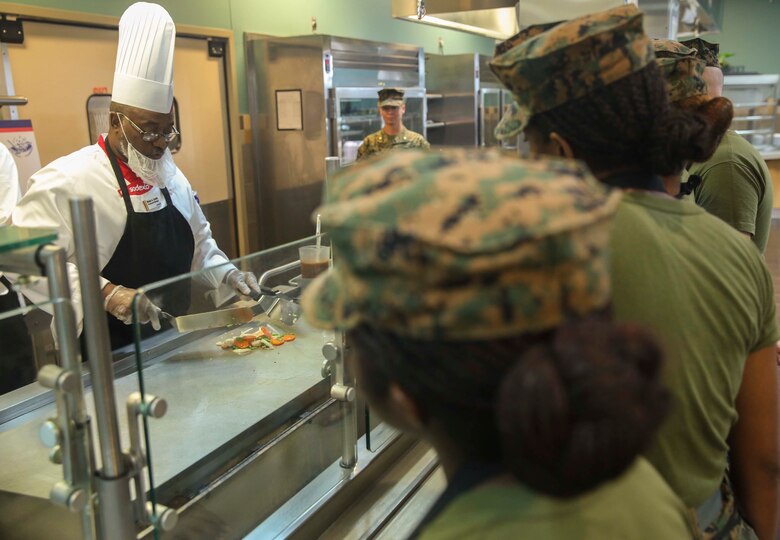 Wade A. Smith, a Sodexo production manager, instructs Marine food service specialist in stir fry training at Mess Hall 128 on Marine Corp Base Camp Lejeune, Sept. 22. The Sodexo Company Quality of Life Services teaches methods to Marine food service specialist to improve the basic services involving in stir fry cooking, steaming, boiling, sautéing food, roasting, braising, stewing and knife skills across the installation. (U.S. Marine Corps photo by Lance Cpl. Tavairus Hernandez)