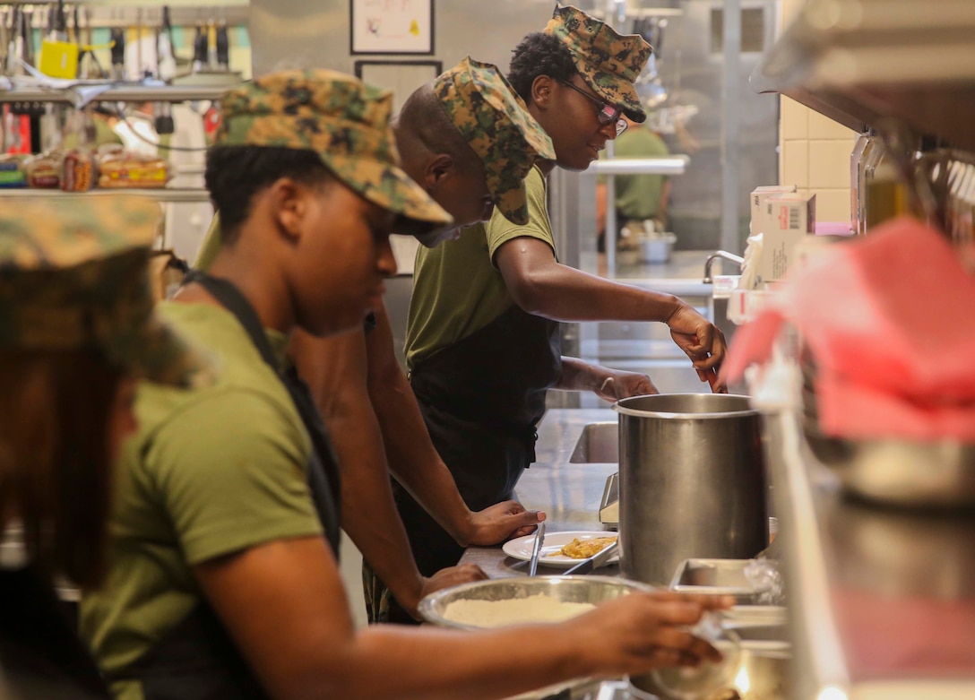 Lance Cpl. Lydia Gulley, a Marine with Marine Wing Support Squadron 271, applies the skills taught about cooking quickly at Mess Hall 128 on Marine Corps Base Camp Lejeune, Sept. 22. The Sodexo Company Quality of Life Services teaches methods to Marine food service specialist to improve the basic services involving in stir fry cooking, steaming, boiling, sautéing food, roasting, braising, stewing and knife skills across the installation. (U.S. Marine Corps photo by Lance Cpl. Tavairus Hernandez)