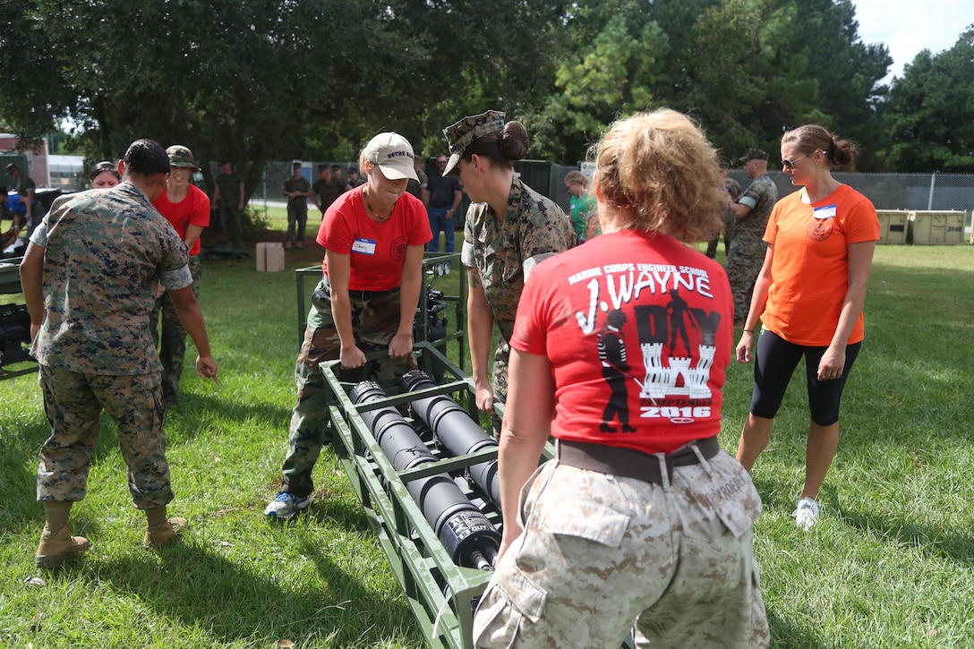 Spouses assemble a water filtration system during a J. Wayne day event at Marine Corps Base Camp Lejeune, Sept. 23. The all-day event required participants to complete several difficult tasks related to the Marine Corps engineer mission. (U.S. Marine Corps photo by Pfc. Juan Madrigal/Released)