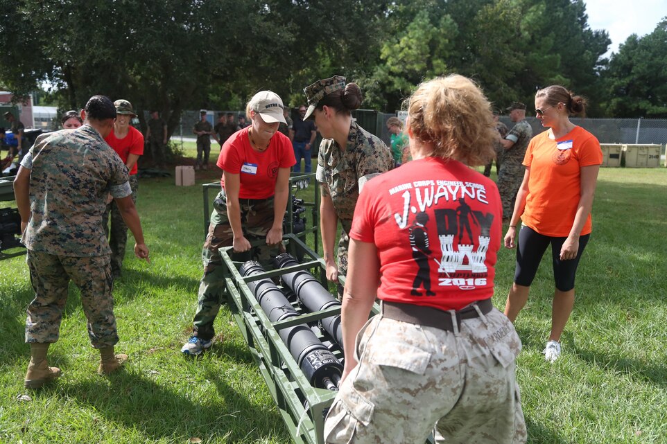 Spouses assemble a water filtration system during a J. Wayne day event at Marine Corps Base Camp Lejeune, Sept. 23. The all-day event required participants to complete several difficult tasks related to the Marine Corps engineer mission. (U.S. Marine Corps photo by Pfc. Juan Madrigal/Released)