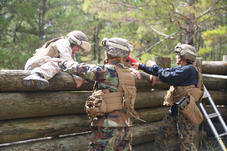 Spouses run through an obstacle course to see how physically demanding their significant others job can be, Sept. 23 at Marine Corps Base Camp Lejeune. The all-day event required participants to complete several difficult tasks related to the Marine Corps engineer mission. (U.S. Marine Corps photo by Pfc. Juan Madrigal/Released)