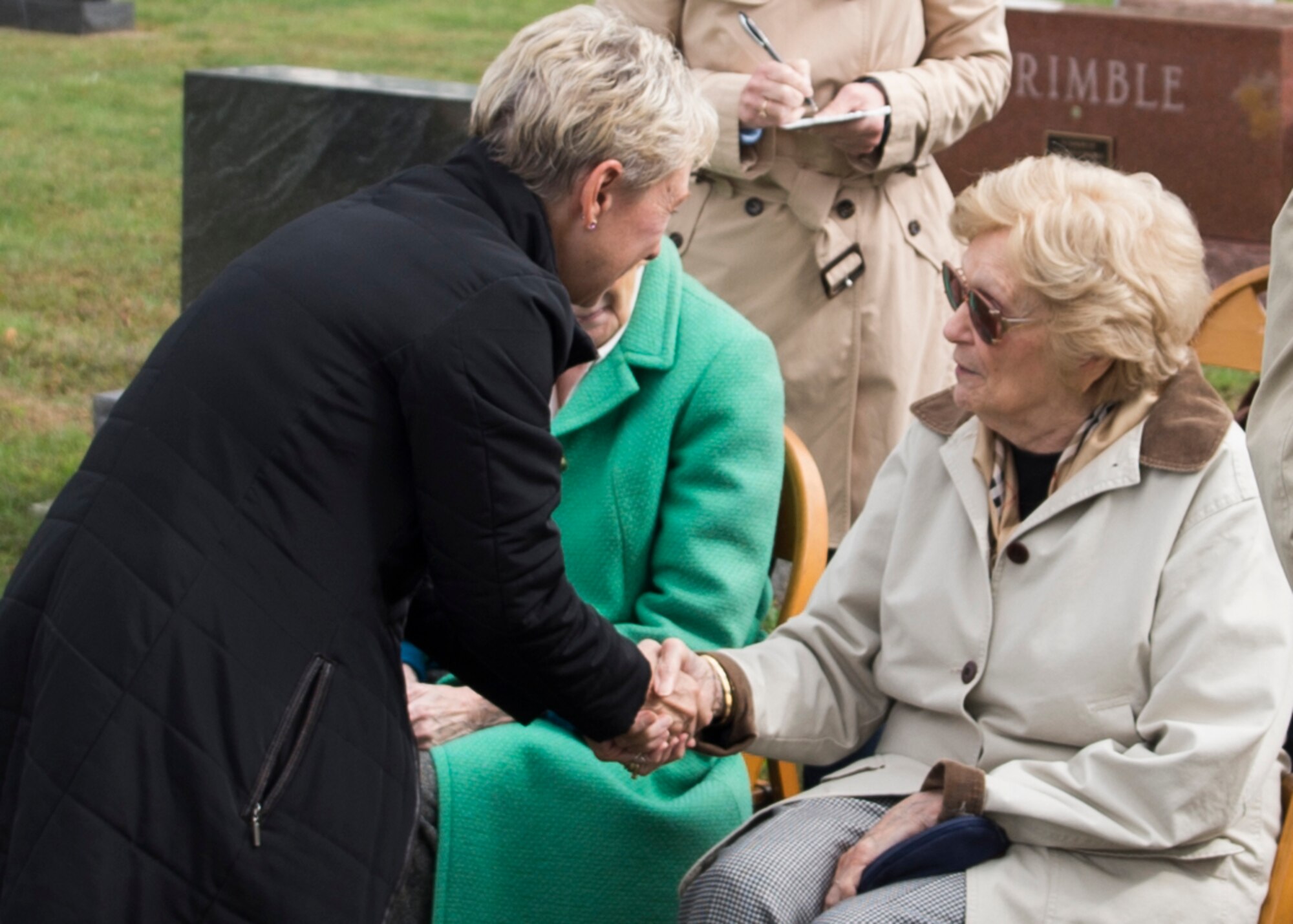 Jeannine Baker-McIntosh is greeted during a ceremony to honor her brother, Army Air Corps Lt. Robert McIntosh, Sept.29, 2016. McIntosh was a fighter pilot during World War II whose plane, a P-38 Lightning, disappeared in Italy on May 22, 1944. (U.S. Air Force photo/Senior Airman Andrew Crawford)