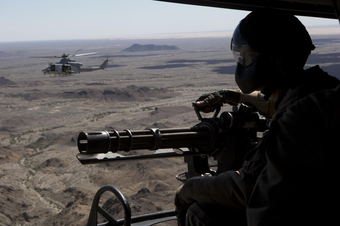 U.S. Marine Corps Cpl. Zachary A. Zimberg, helicopter crew chief with Marine Light Attack Helicopter Squadron 169, 3rd Marine Aircraft Wing prepares to engage a target with a GAU-17/A gatling gun during an offensive air support exercise at Chocolate Mountain Aerial Gunnery Range, Calif., Sept. 28, 2016. This exercise was a part of Weapons and Tactics Instructor Course 1-17, a seven week training event, hosted by Marine Aviation Weapons and Tactics Squadron One cadre, which emphasizes operational integration of the six functions of Marine Corps aviation in support of a Marine Air Ground Task Force. MAWTS-1 provides standardized advanced tactical training and certification of unit instructor qualifications to support Marine Aviation Training and Readiness and assists in developing and employing aviation weapons and tactics. 